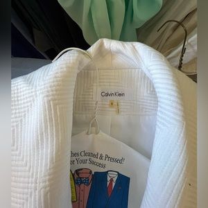 Women’s white business blazer the brand is Calvin Klein size 8 with a black belt